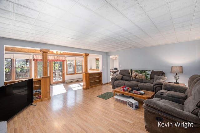 living room with light hardwood / wood-style flooring and a baseboard radiator