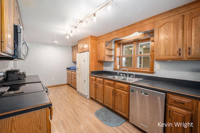 kitchen with light wood-type flooring, stainless steel appliances, and sink
