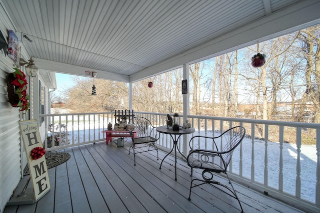 deck with a water view and covered porch