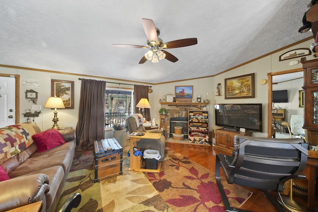 living room featuring ceiling fan, a textured ceiling, and hardwood / wood-style flooring