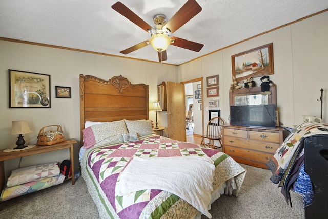 bedroom featuring ceiling fan, crown molding, carpet floors, and a textured ceiling