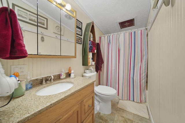 full bathroom with vanity, shower / bath combo, tile patterned floors, toilet, and a textured ceiling