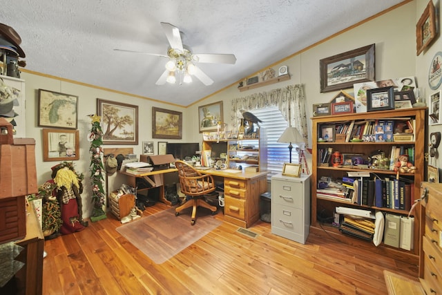 office space with ceiling fan, vaulted ceiling, a textured ceiling, and light hardwood / wood-style flooring