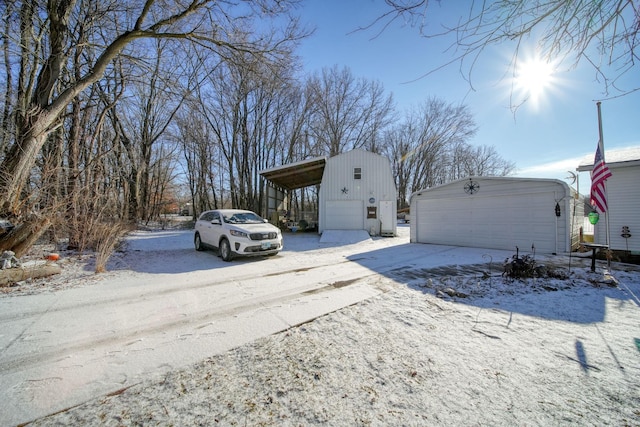 exterior space with a garage and an outbuilding