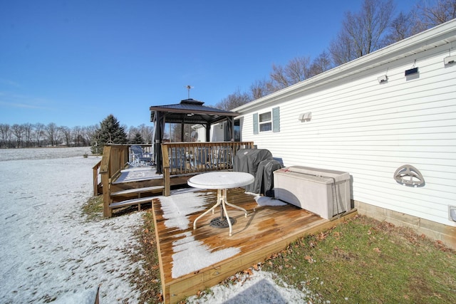 snow covered deck featuring a gazebo and grilling area