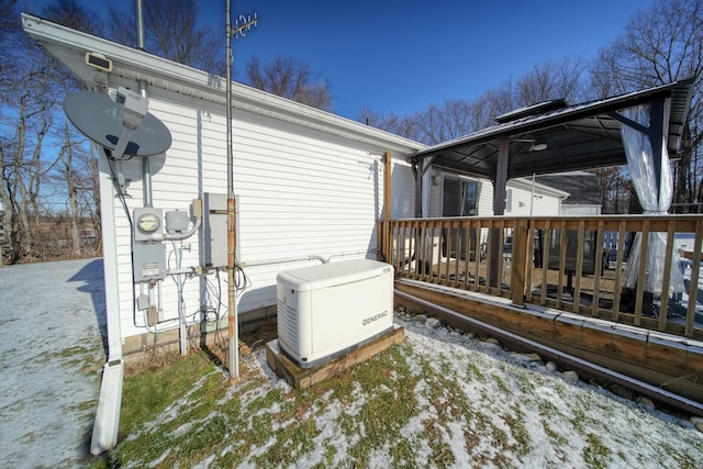 snow covered property featuring a wooden deck