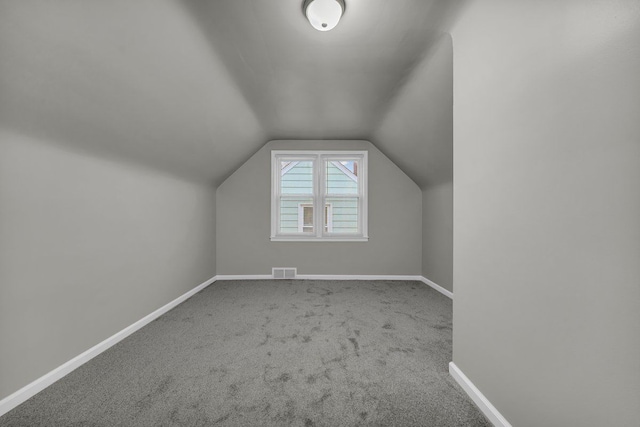 bonus room featuring lofted ceiling and carpet floors