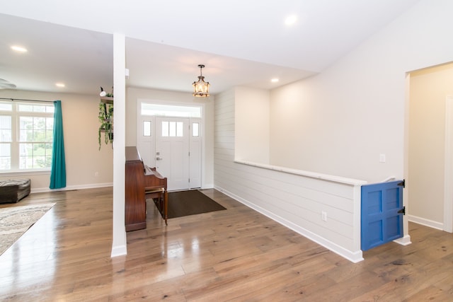 foyer with light hardwood / wood-style flooring and a notable chandelier