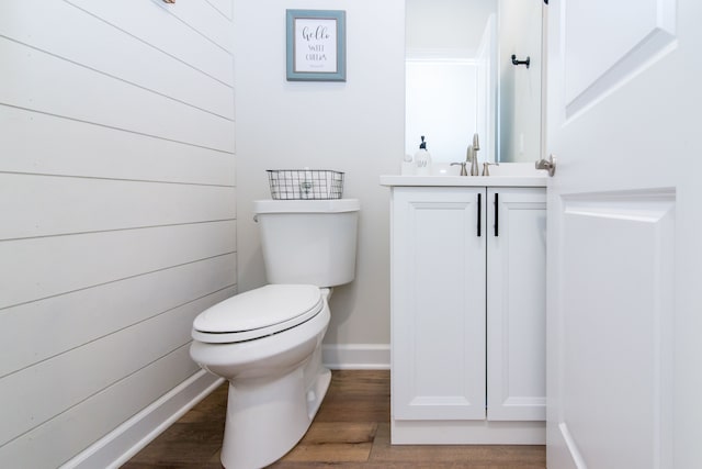 bathroom featuring hardwood / wood-style floors, vanity, and toilet