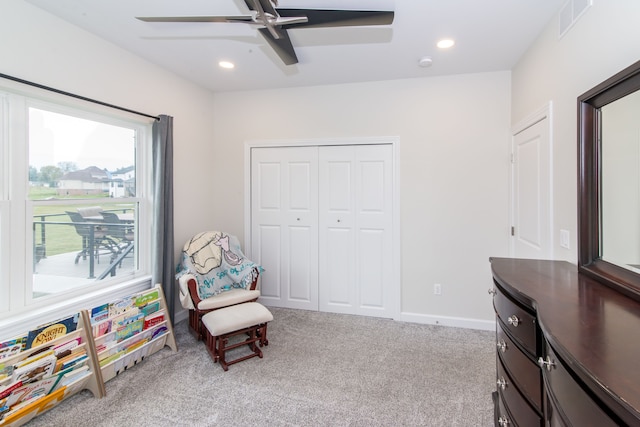 living area featuring ceiling fan and light carpet