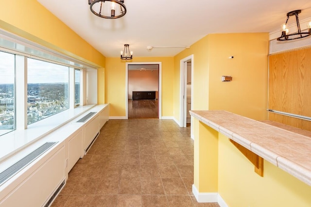 hallway with a chandelier