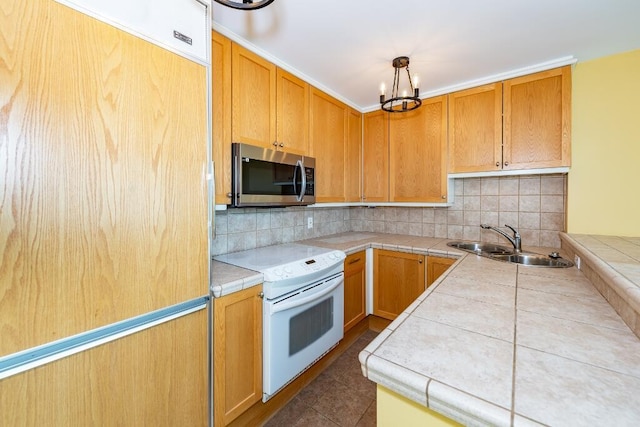 kitchen with tile countertops, white electric range oven, sink, and tasteful backsplash