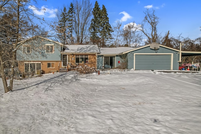 view of front of home with a garage and a carport