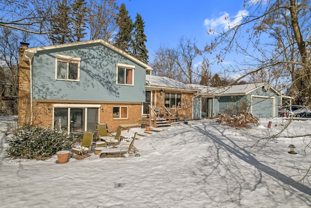 snow covered property with a garage