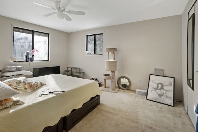 carpeted bedroom featuring a closet and ceiling fan