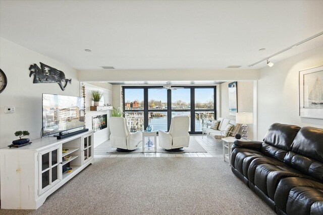 living room with rail lighting and light tile patterned floors