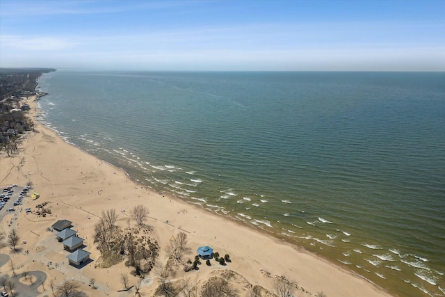 drone / aerial view featuring a water view and a view of the beach