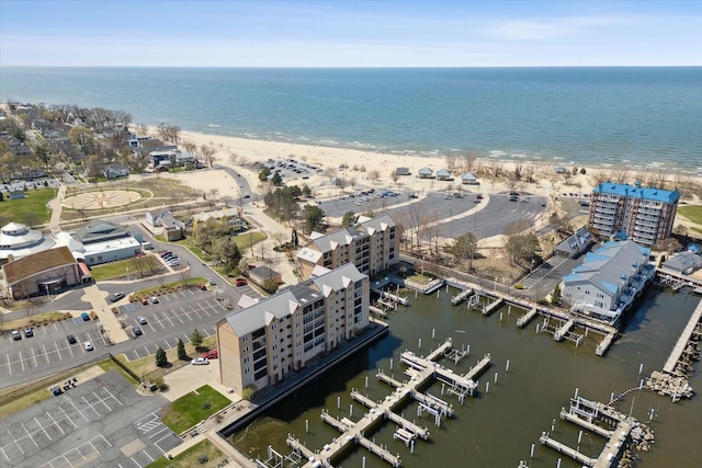 birds eye view of property with a beach view and a water view
