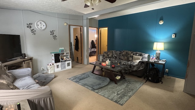 living room with carpet, ceiling fan, and a textured ceiling