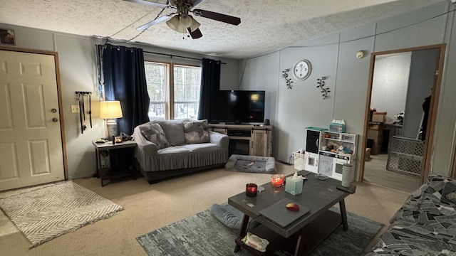 living room featuring ceiling fan, carpet floors, and a textured ceiling