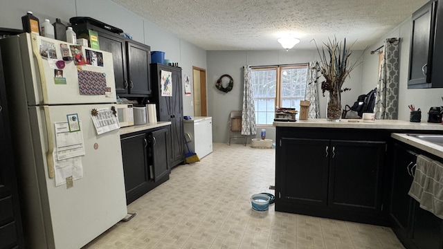 kitchen featuring white appliances and a textured ceiling