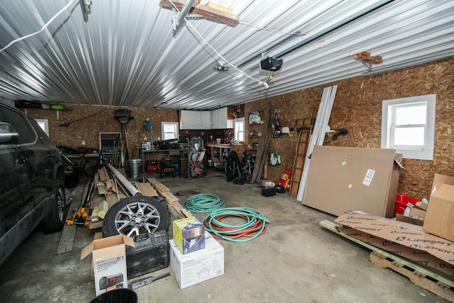 garage with a workshop area and a garage door opener