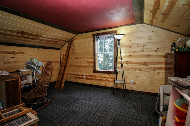 additional living space with wood walls, lofted ceiling, and wooden ceiling