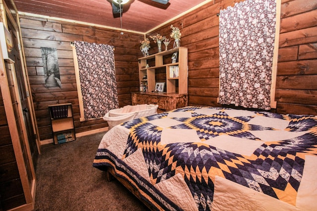 carpeted bedroom featuring rustic walls, ceiling fan, and wood ceiling