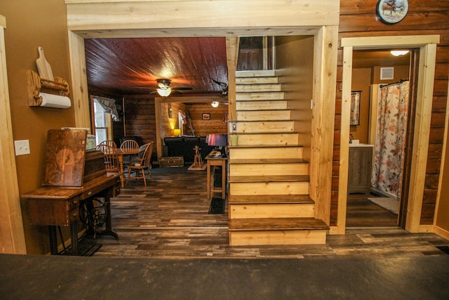 staircase featuring hardwood / wood-style floors and wooden ceiling