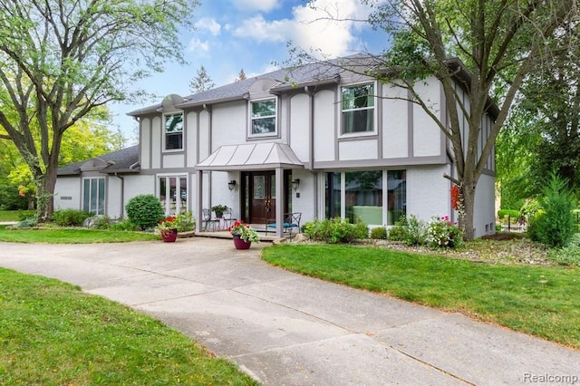 tudor home featuring a front yard