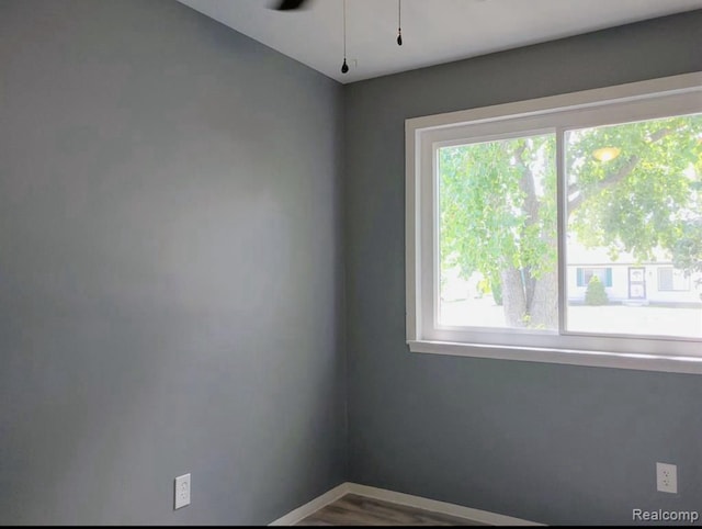 unfurnished room featuring ceiling fan and a healthy amount of sunlight