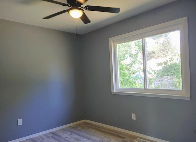 spare room with ceiling fan and light wood-type flooring