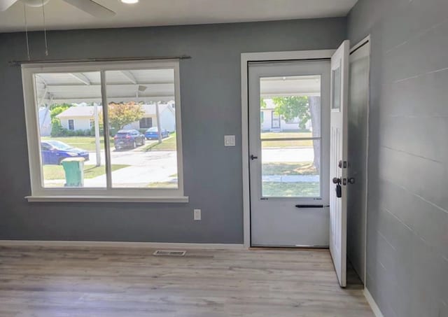 entryway featuring a wealth of natural light, light hardwood / wood-style flooring, and ceiling fan