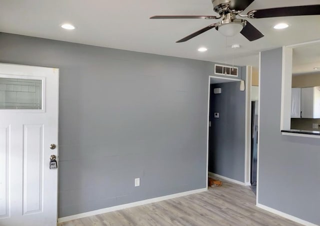 empty room with light hardwood / wood-style floors and ceiling fan