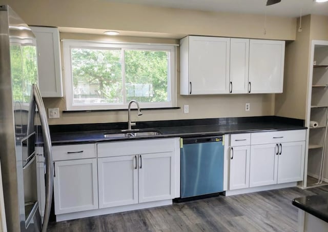 kitchen with dark wood-type flooring, sink, ceiling fan, white cabinetry, and stainless steel appliances