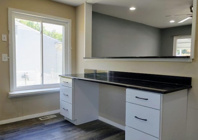 unfurnished office featuring ceiling fan and dark hardwood / wood-style flooring