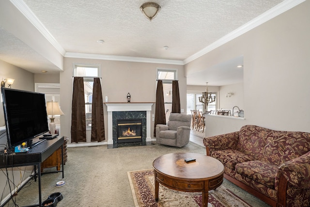 living room featuring ornamental molding, a premium fireplace, a textured ceiling, and a chandelier