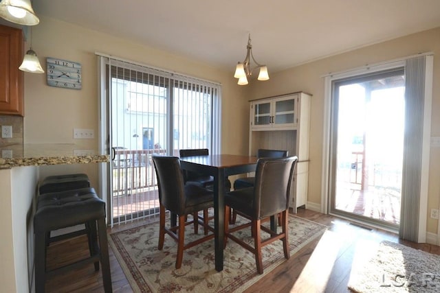 dining area featuring a chandelier and dark hardwood / wood-style floors