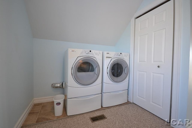 washroom with washer and dryer and light tile patterned flooring