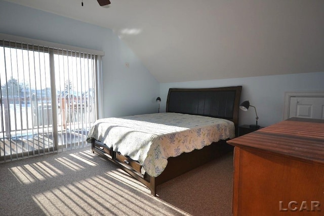 carpeted bedroom featuring access to outside, vaulted ceiling, ceiling fan, and a water view