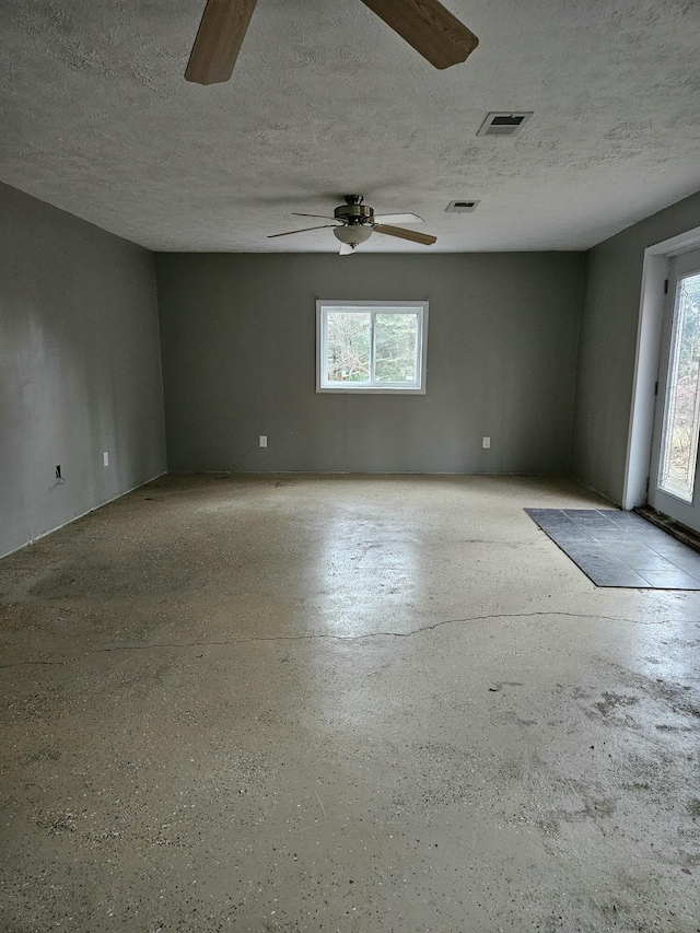 unfurnished room with a textured ceiling