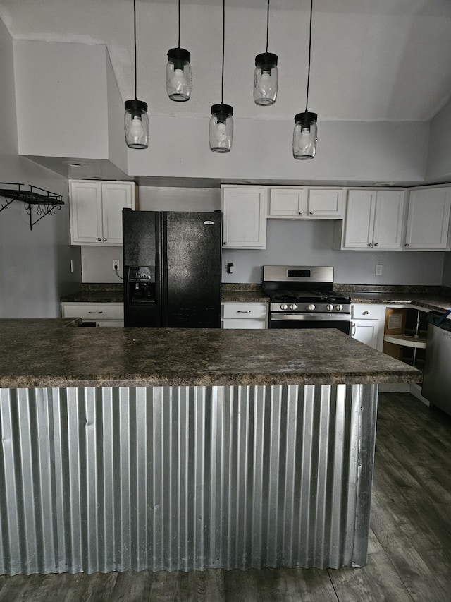 kitchen with white cabinets, appliances with stainless steel finishes, dark hardwood / wood-style flooring, and hanging light fixtures