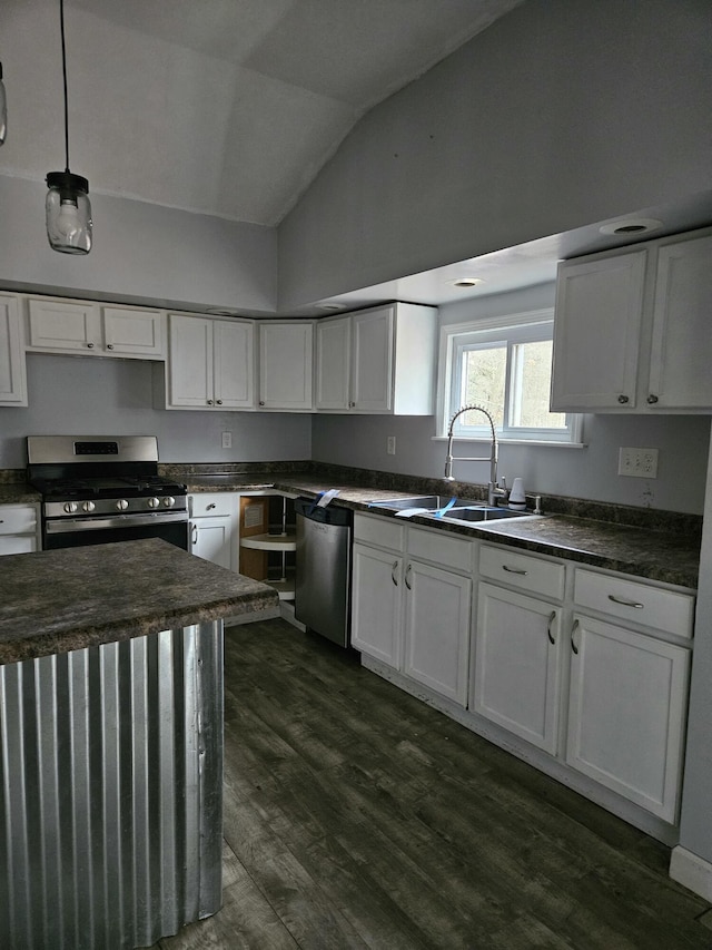 kitchen with white cabinetry, sink, decorative light fixtures, vaulted ceiling, and appliances with stainless steel finishes