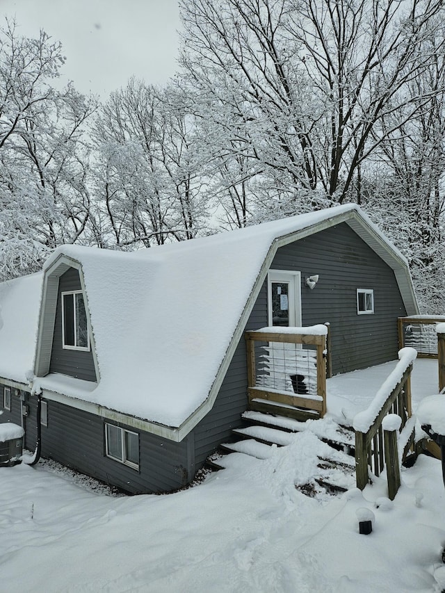 snow covered property with cooling unit