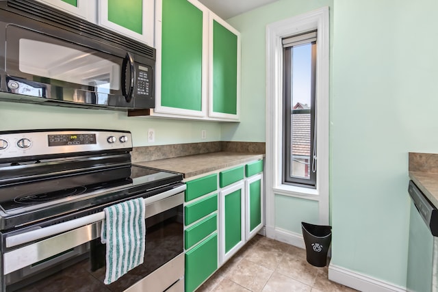 kitchen featuring appliances with stainless steel finishes, light tile patterned floors, white cabinetry, and green cabinets