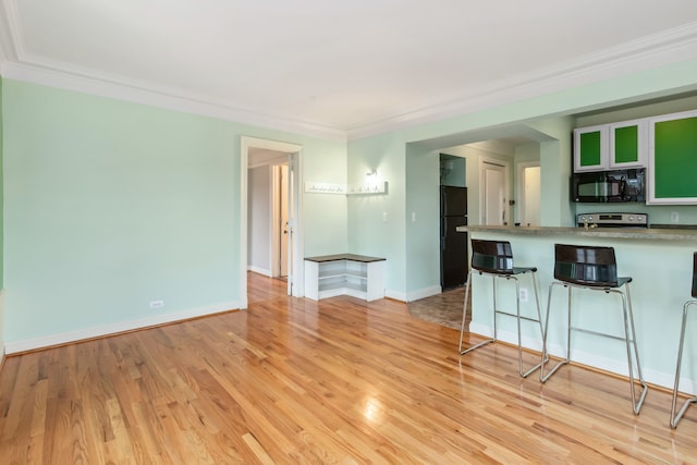 interior space featuring light wood-type flooring and crown molding