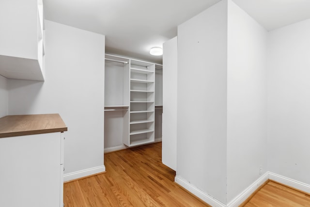 walk in closet featuring light hardwood / wood-style flooring