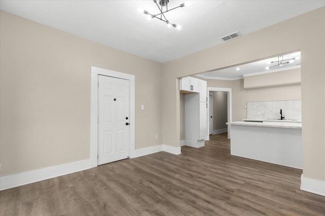 unfurnished living room with sink and dark wood-type flooring