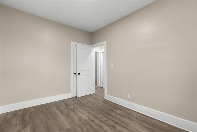 unfurnished room with hardwood / wood-style flooring