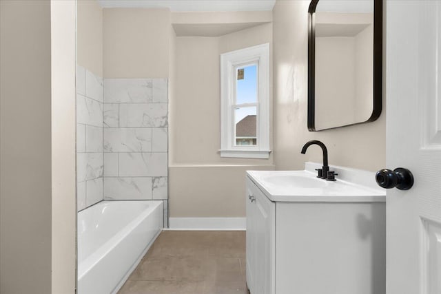 bathroom with tile patterned floors, vanity, and tiled shower / bath